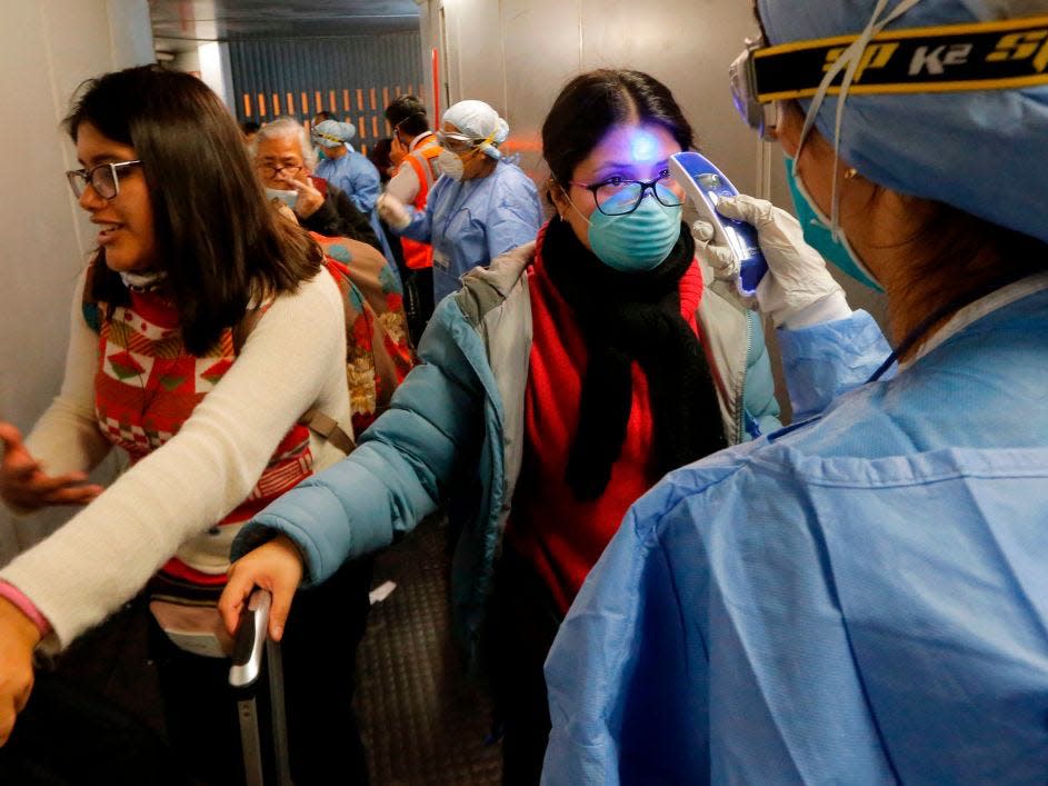 Peruvian citizens being scanned at the airport for fever.