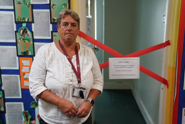 Caroline Evans, head teacher of Parks Primary School in Leicester stands next to a taped off section inside the school