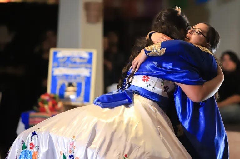 Karina and Jessica dance in a close embrace during the mother-daughter dance at her quinceañera celebration.