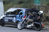 Bikers ride past a media van at the scene of a mass shooting at Cook's Corner, Thursday, Aug. 24, 2023, in Trabuco Canyon, Calif. (AP Photo/Damian Dovarganes)