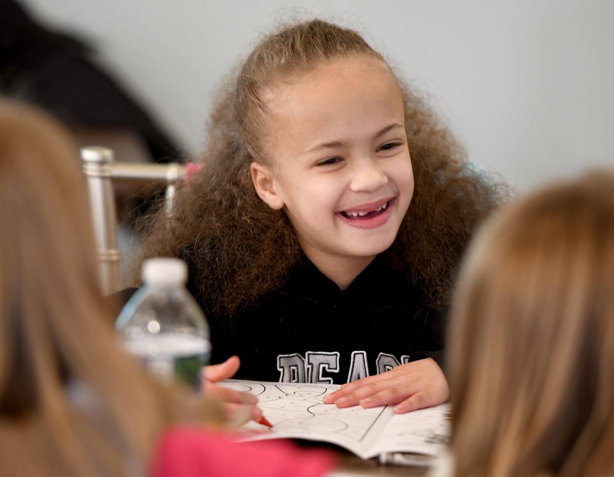 Brandyn Bankson, a second grade student in the Summit Arts Academy class of Lisa Artimez and Amy Kiss, visits with friend during a craft time at Canton's 10th annual Arbor Day Celebration at Canton Garden Center.