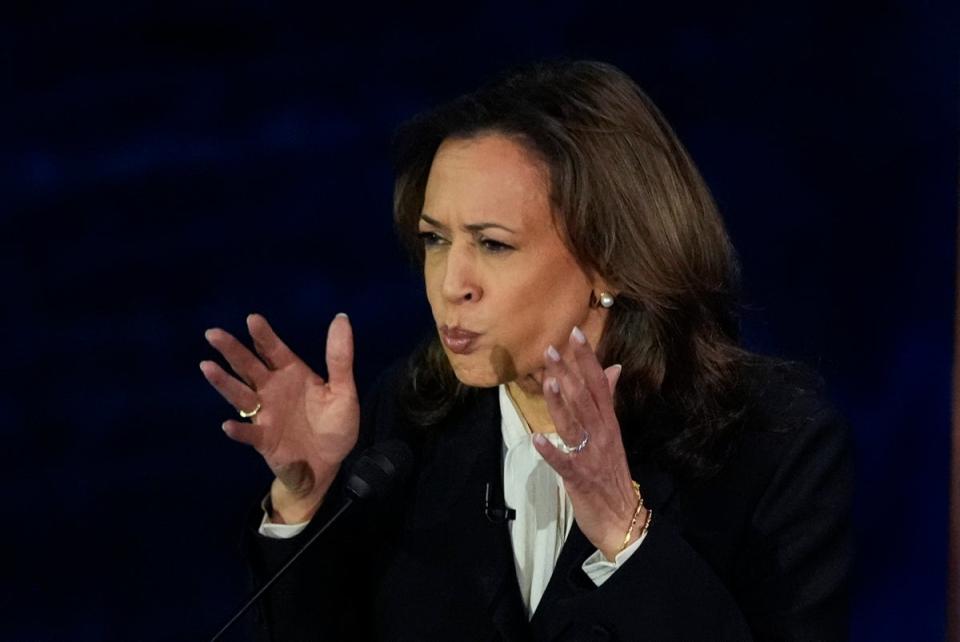 Harris listens to Trump during debate. She only brought up his rallies, knocking him out of the game. (AP)