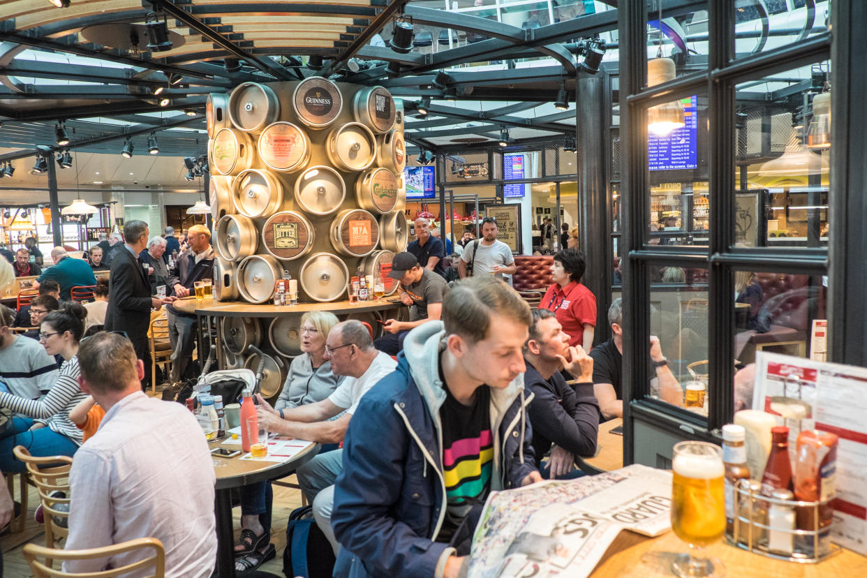 People in a pub in Manchester Airport. (PA)