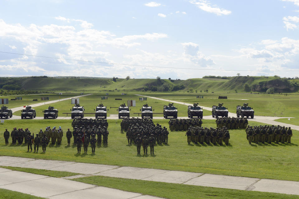 In this photo provided by the Serbian Defense Ministry, Russian and Serbian soldiers perform during exercise in Deliblatska Pescara, a large sand area, 70 kilometers north-west of Belgrade, Serbia. Serbia and Russia on Thursday launched joint military exercise in the Balkan country as the US-led forces held massive drills in neighboring states in what appeared to be Moscow's resolve to maintain influence in the European region torn by wars in the 1990s. (Serbian Defense Ministry Press Service via AP)