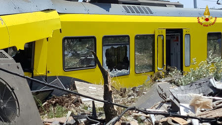 A damaged passenger train is seen after a collision with another in the middle of an olive grove in the southern village of Corato, near Bari, Italy, in this handout picture released by Italian Firefighters July 12, 2016. Italian Firefighters/handout via Reuters