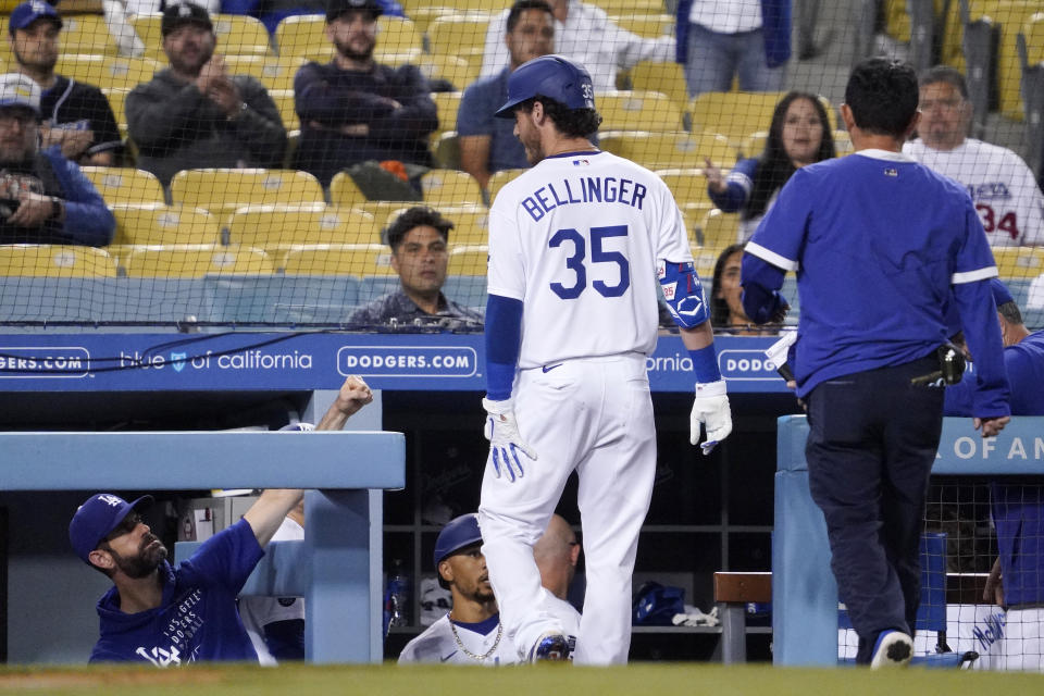 Los Angeles Dodgers' Cody Bellinger holds the back of his leg after being taken out of the game during the fifth inning of a baseball game against the Texas Rangers Friday, June 11, 2021, in Los Angeles. (AP Photo/Mark J. Terrill)