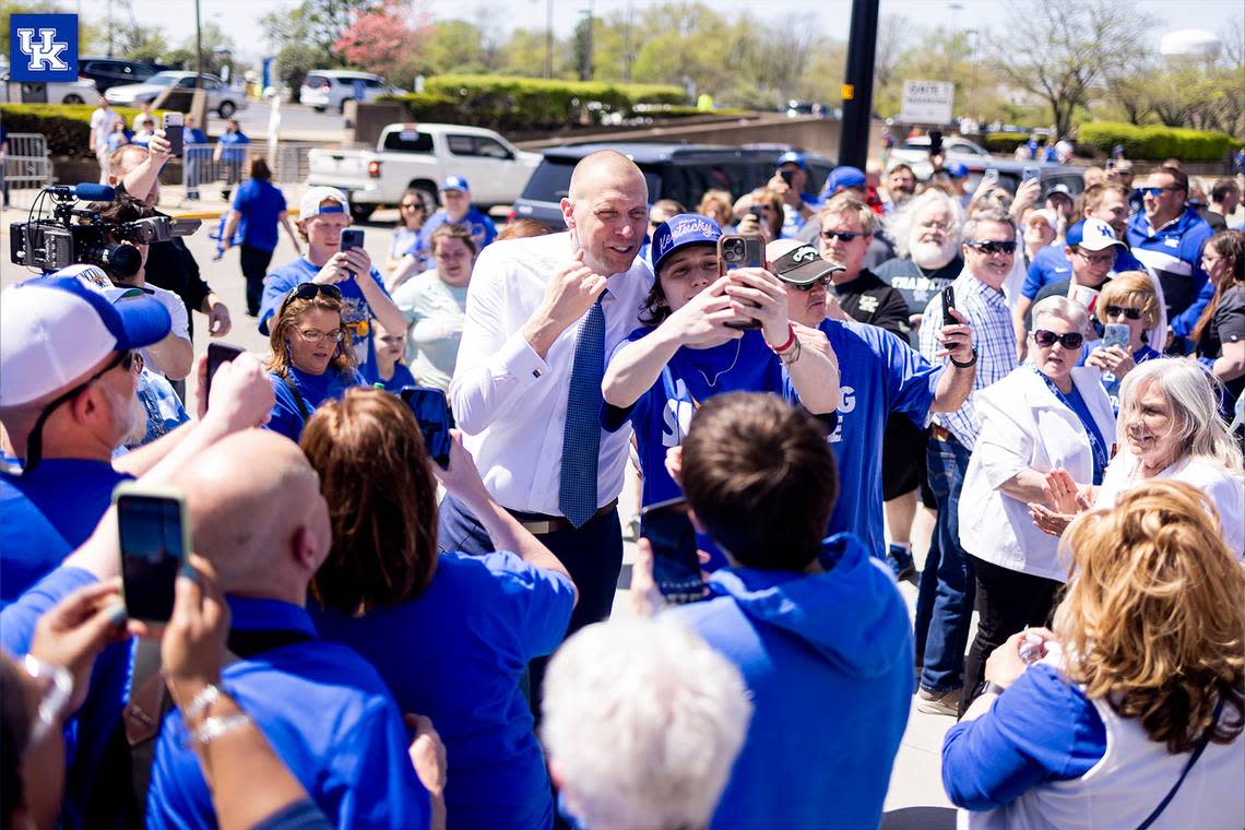 New Kentucky men’s basketball coach Mark Pope poses for pictures with fans waiting in line outside Rupp Arena on Sunday before Pope’s introductory press conference inside.