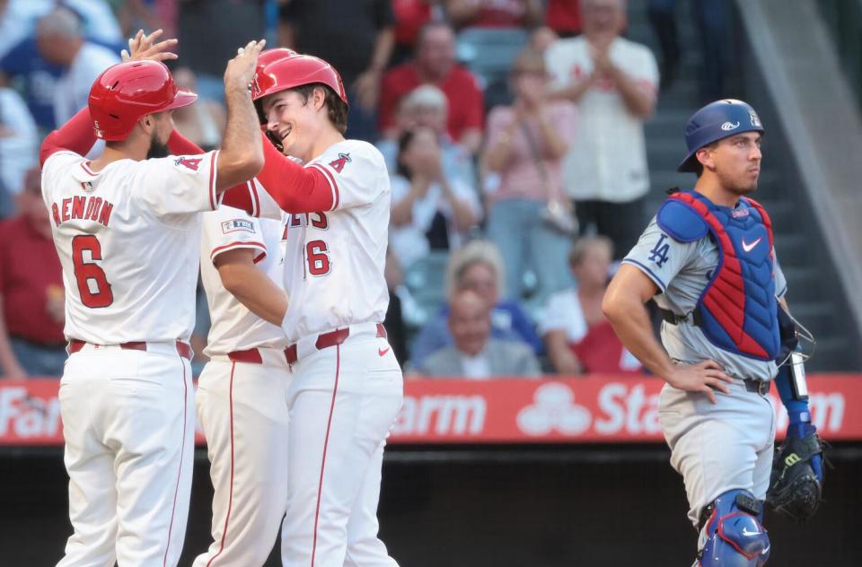 Angels Mickey Moniak, center right, celebrates his three-run home run with Anthony Rendon.