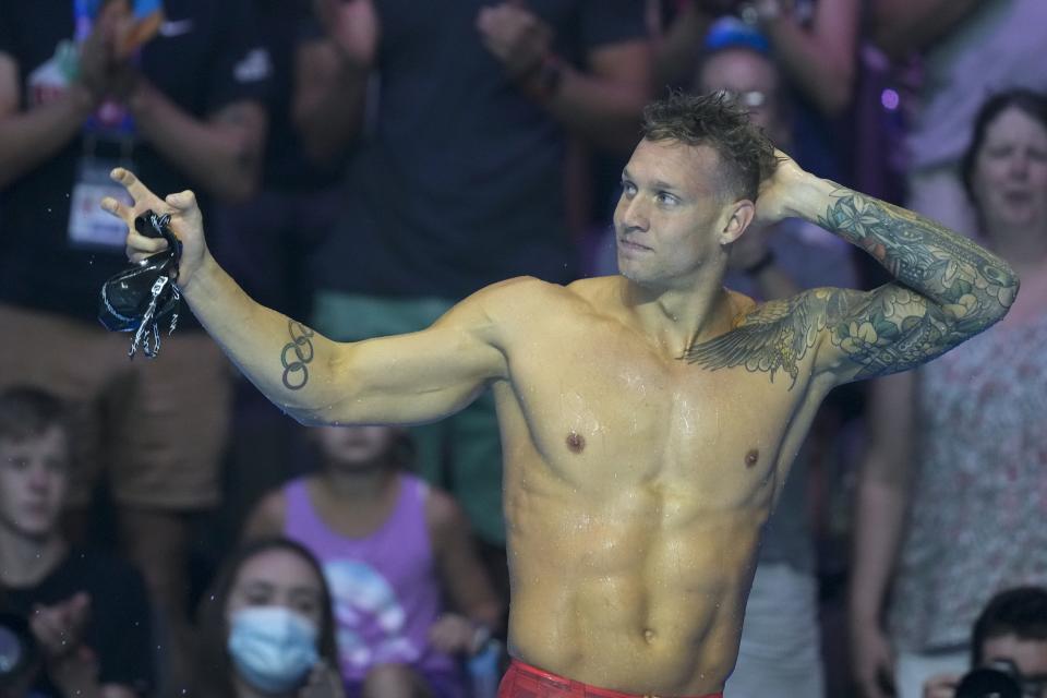 Caeleb Dressel reacts after winning the men's 50 freestyle during wave 2 of the U.S. Olympic Swim Trials on Sunday, June 20, 2021, in Omaha, Neb. (AP Photo/Charlie Neibergall)