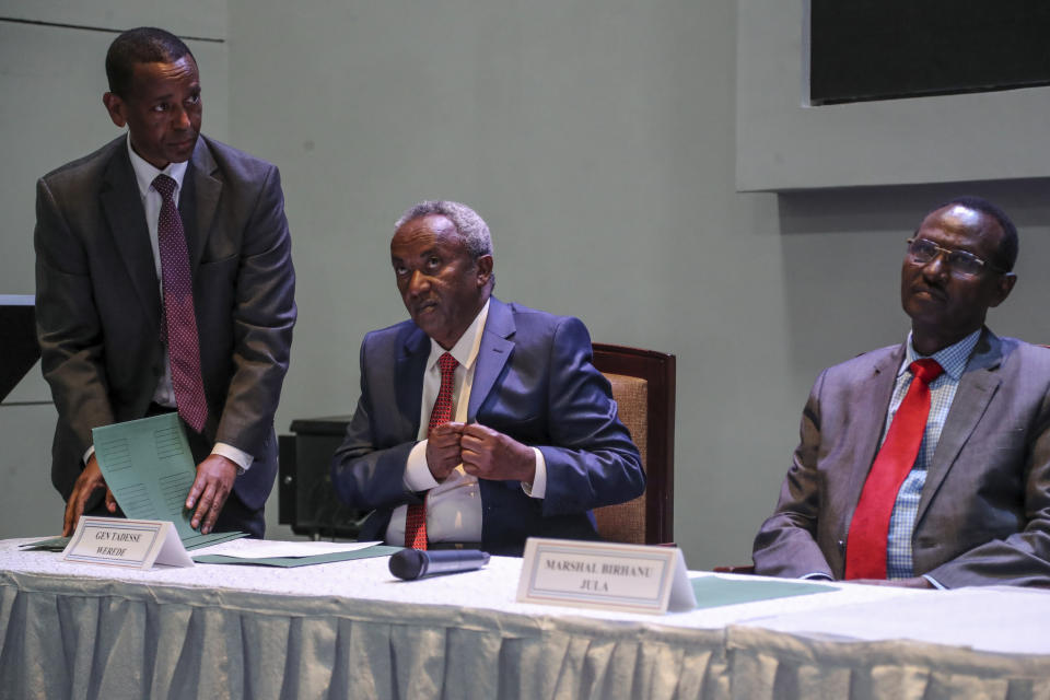 Head of the Tigray Forces Lieutenant General Tadesse Werede, left, takes out a pen as he and Chief of Staff of Ethiopian Armed Forces Field Marshall Birhanu Jula, right, prepare to sign an agreement at Ethiopian peace talks in Nairobi, Kenya Saturday, Nov. 12, 2022. Top military commanders from Ethiopia and its embattled Tigray region agreed Saturday to allow unhindered humanitarian access to the region and form a joint disarmament committee following last week's truce. (AP Photo/Brian Inganga)