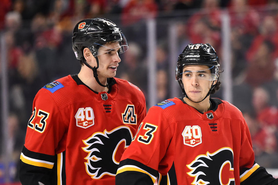 CALGARY, AB - NOVEMBER 13: Calgary Flames Center Sean Monahan (23) and Left Wing Johnny Gaudreau (13) talk before a whistle during the third period of an NHL game where the Calgary Flames hosted the Dallas Stars on November 13, 2019, at the Scotiabank Saddledome in Calgary, AB. (Photo by Brett Holmes/Icon Sportswire via Getty Images)