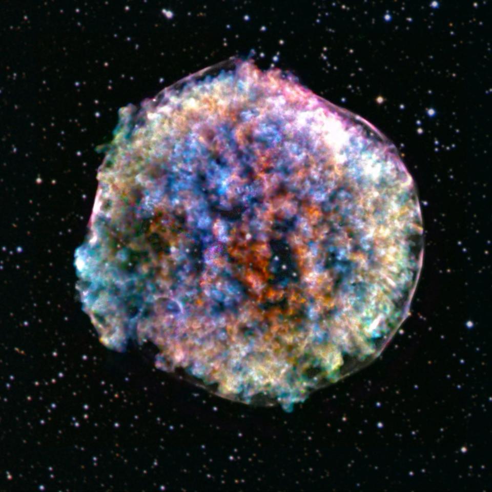 supernova remnant in space clumpy colorful textured bubble with shades of red orange blue yellow green purple white