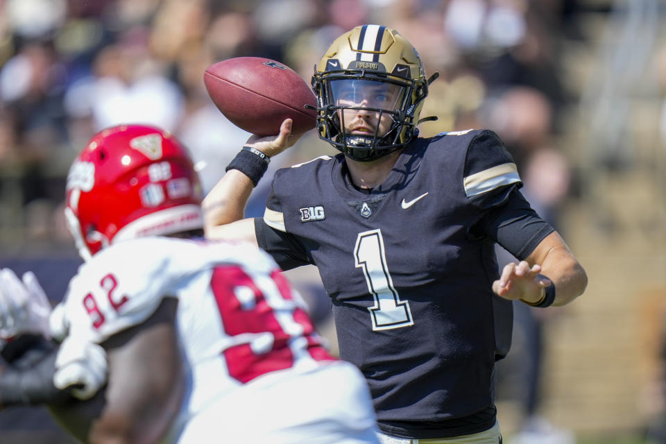 Purdue quarterback Hudson Card (1) throws over Fresno State defensive lineman Gavriel Lightfoot (92) during the first half of an NCAA college football game in West Lafayette, Ind., Saturday, Sept. 2, 2023. (AP Photo/AJ Mast)