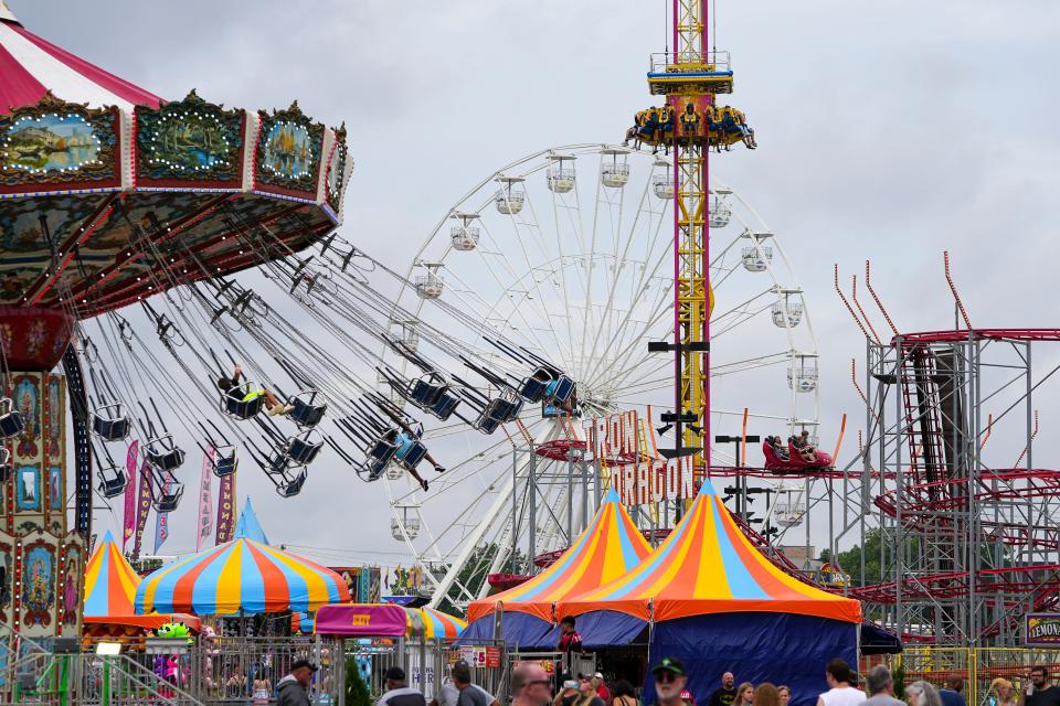 Visitors spin, drop and soar on the midway rides at the Ohio State Fair.