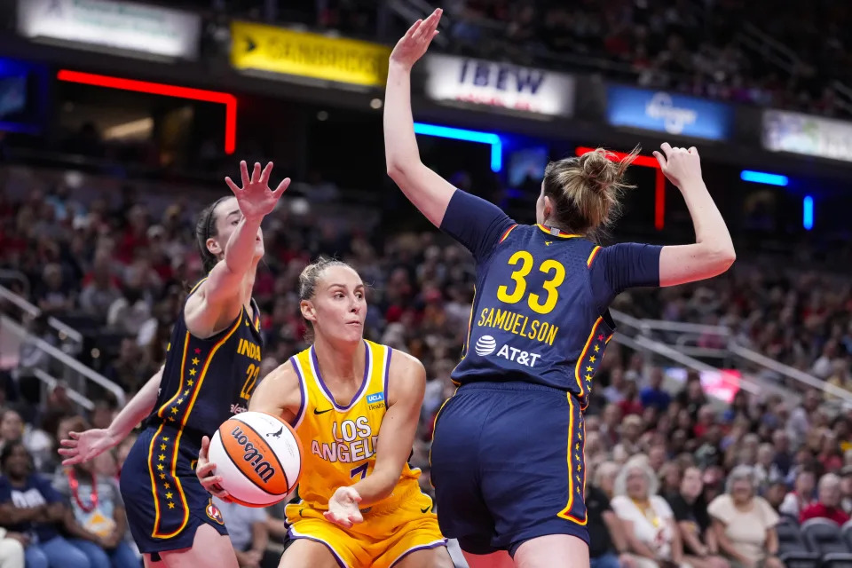 Los Angeles Sparks forward Stephanie Talbot (7) makes a pass between Indiana Fever forward Katie Lou Samuelson (33) and guard Caitlin Clark (22) in the first half of a WNBA basketball game in Indianapolis, Wednesday, Sept. 4, 2024. (AP Photo/Michael Conroy)