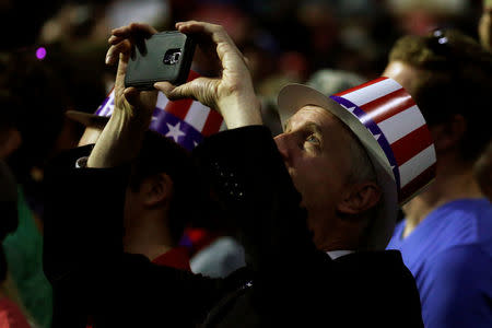 A supporter takes a photo of Republican presidential nominee Donald Trump during a campaign rally in Everett, Washington, U.S., August 30, 2016. REUTERS/Carlo Allegri