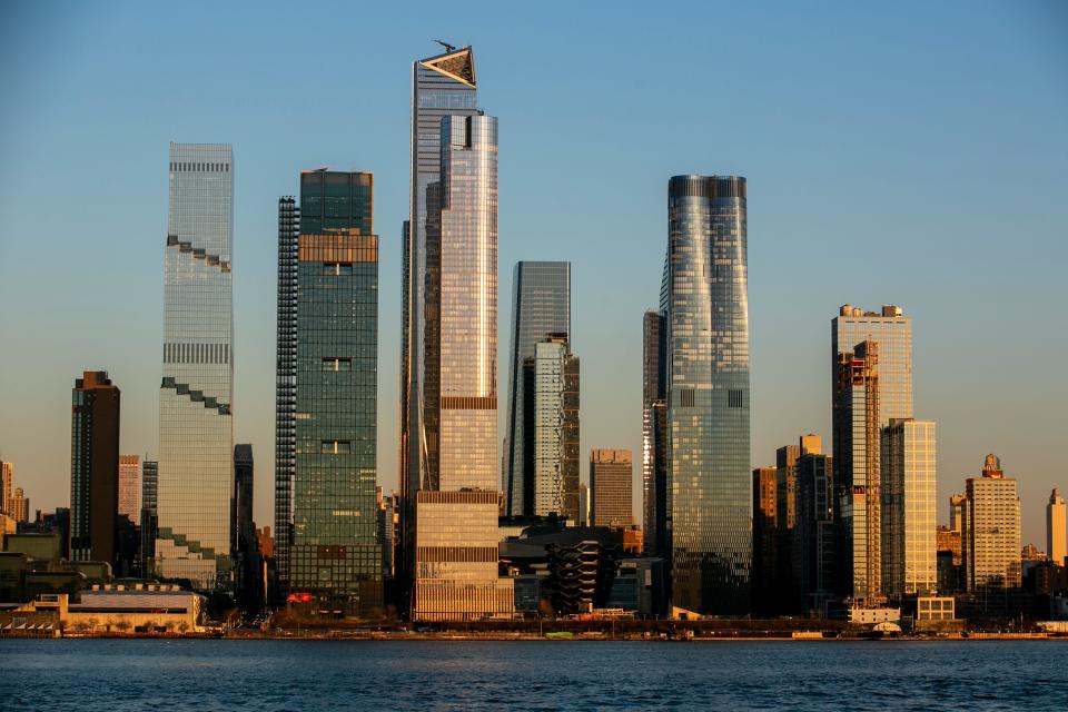 Light from the setting sun falls on the Hudson Yards neighborhood in the borough of Manhattan in New York City, as seen from the Weehawken Pier in Weehawken, N.J., Wednesday, March 22, 2023.