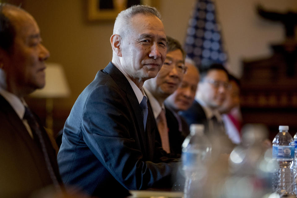 Chinese Vice Premier Liu He, center, accompanied by other Chinese officials, begin US-China Trade Talks with US Trade Representative Robert Lighthizer and other members of President Donald Trump's cabinet in the Diplomatic Room of the Eisenhower Executive Office Building on the White House Complex, Wednesday, Jan. 30, 2019, in Washington. Also pictured is China's Central Bank Governor Yi Gang, center right. (AP Photo/Andrew Harnik)