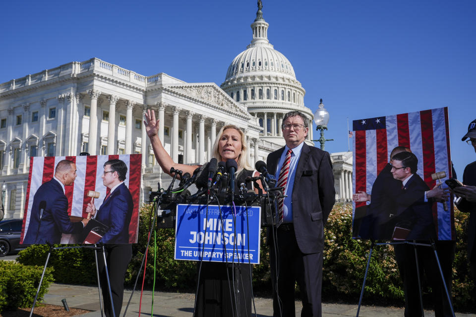 Rep. Marjorie Taylor Greene, R-Ga., joined by Rep. Thomas Massie, R-Ky., says she'll call a vote next week on ousting House Speaker Mike Johnson, R-La., during a news conference at the Capitol in Washington, Wednesday, May 1, 2024. Rep. Greene, a staunch ally of former President Donald Trump, is forcing her colleagues to choose sides after Democratic leaders announced they'd provide the votes to save the Republican speaker's job. (AP Photo/J. Scott Applewhite)