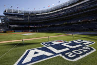 The field is prepped with signage for the American League Championship Series between the New York Yankees and the Houston Astros at Yankee Stadium, Monday, Oct. 14, 2019, in New York. Game 4 in the series, tied at 1-1, is scheduled for Tuesday. (AP Photo/Kathy Willens)
