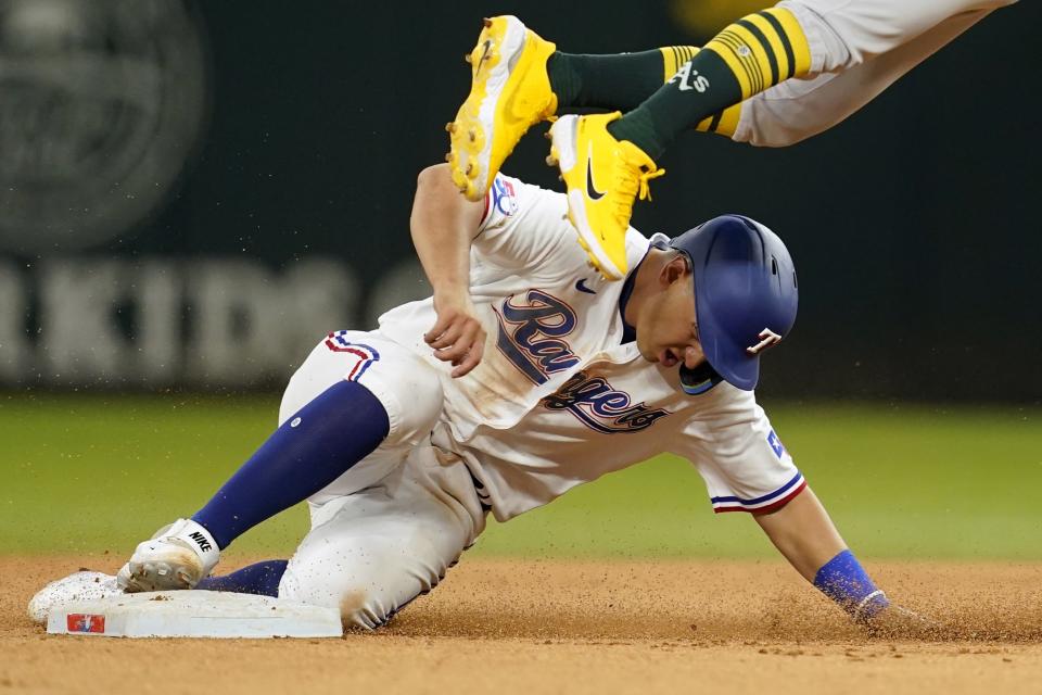 Texas Rangers' Mark Mathias steals second as Oakland Athletics second baseman Tony Kemp, top, leaps to catch the high throw to the bag in the seventh inning of a baseball game in Arlington, Texas, Wednesday, Sept. 14, 2022. (AP Photo/Tony Gutierrez)