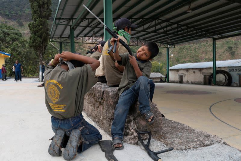 The Wider Image: "Under siege": Inside Mexican village where children are armed