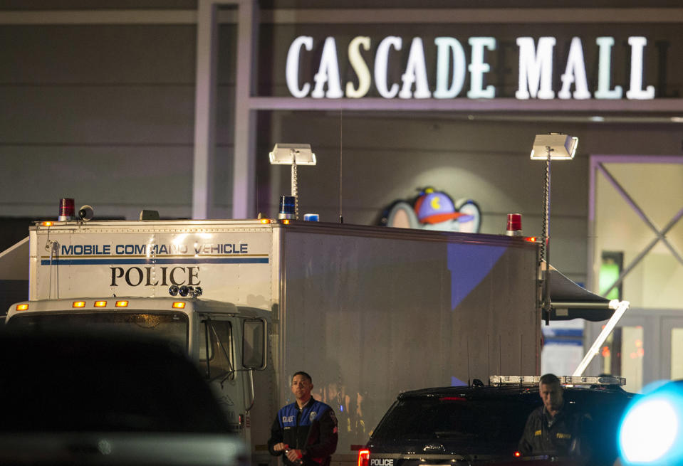 <p>Law enforcement officers stand near a mobile police command center at the scene of a shooting where several people were killed Friday, Sept. 23, 2016 in Burlington, Wash. Police searched Saturday for a gunman who opened fire in the makeup department of a Macy’s store at the mall north of Seattle, killing several females, before fleeing toward an interstate on foot, authorities said. (AP Photo/Stephen Brashear) </p>