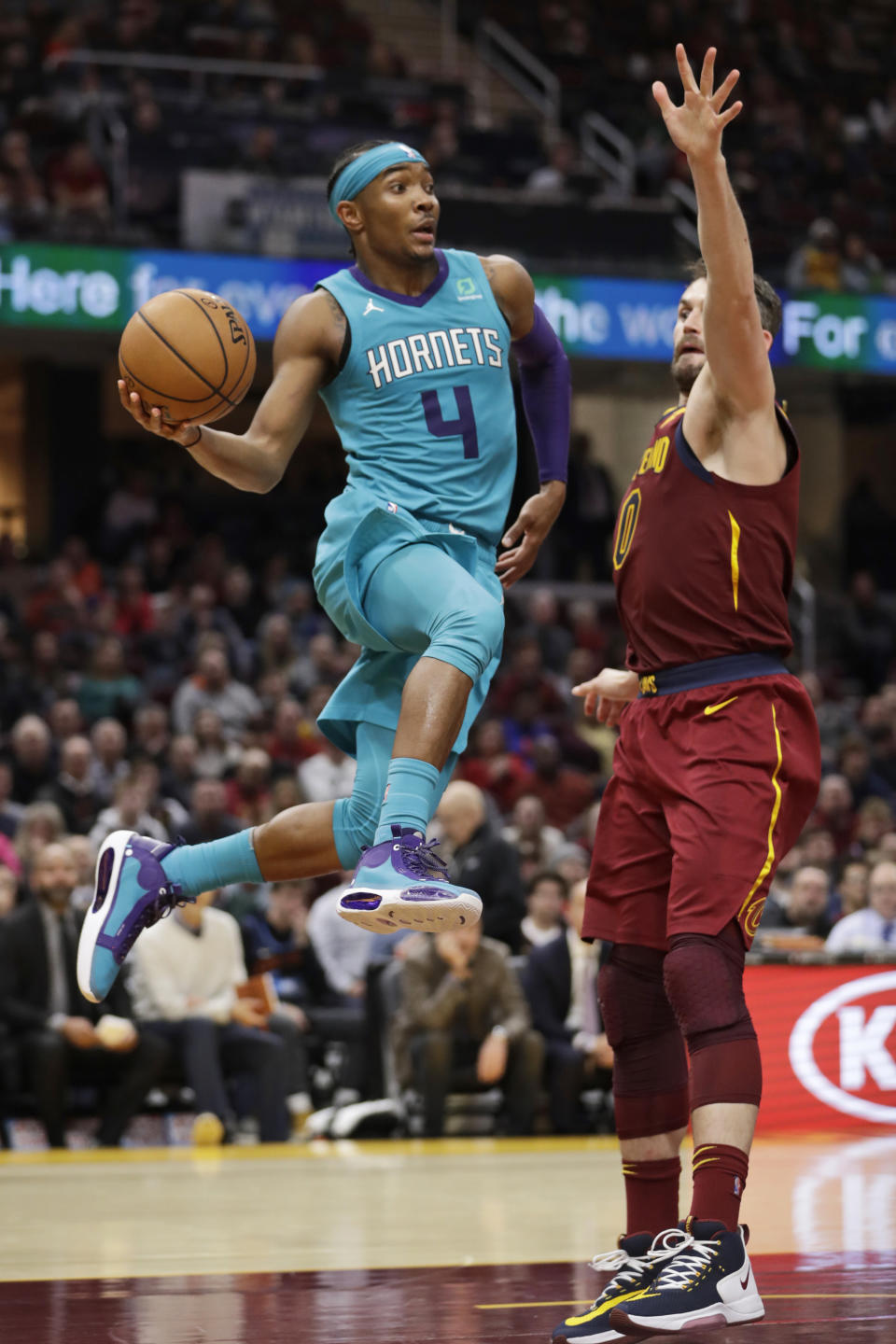 Charlotte Hornets' Devonte' Graham (4) looks to pass against Cleveland Cavaliers' Kevin Love (0) in the second half of an NBA basketball game, Thursday, Jan. 2, 2020, in Cleveland. (AP Photo/Tony Dejak)