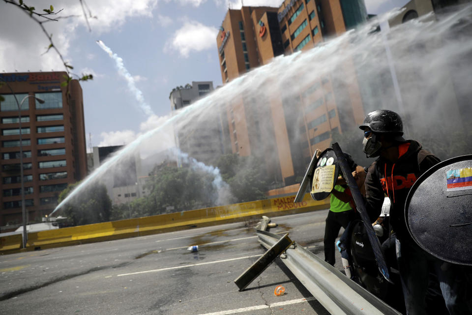 <p>A jet of water is aimed at demonstrators during a rally against Venezuela’s President Nicolas Maduro in Caracas, Venezuela, May 26, 2017. (Carlos Barria/Reuters) </p>