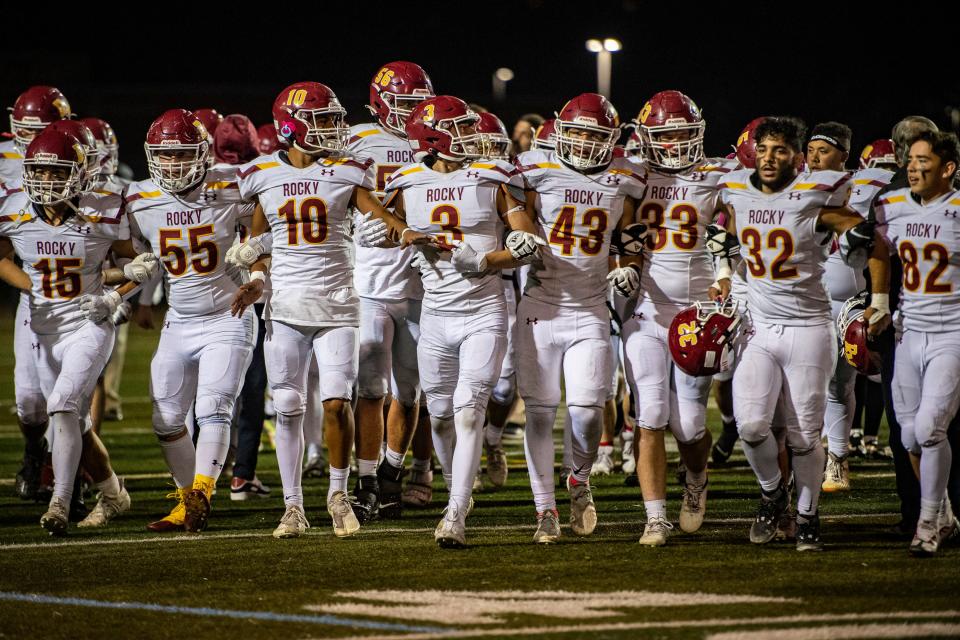 Rocky Mountain High School football players join arms and march toward their fans after defeating crosstown rival Fort Collins 21-0 on Friday night at French Field.
