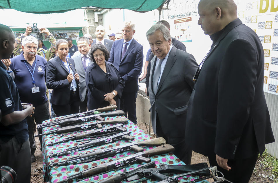 United Nations Secretary-General Antonio Guterres, center-right, views decommissioned weapons at a center for ex-combatants at Muningi, near Goma, in eastern Congo Saturday, Aug. 31, 2019. Guterres is starting a three-day visit to Congo to see the work of UN peacekeepers, work on disarmament and reintegration of ex-combatants, and efforts to stop the spread of the Ebola virus. (AP Photo/Justin Kabumba)