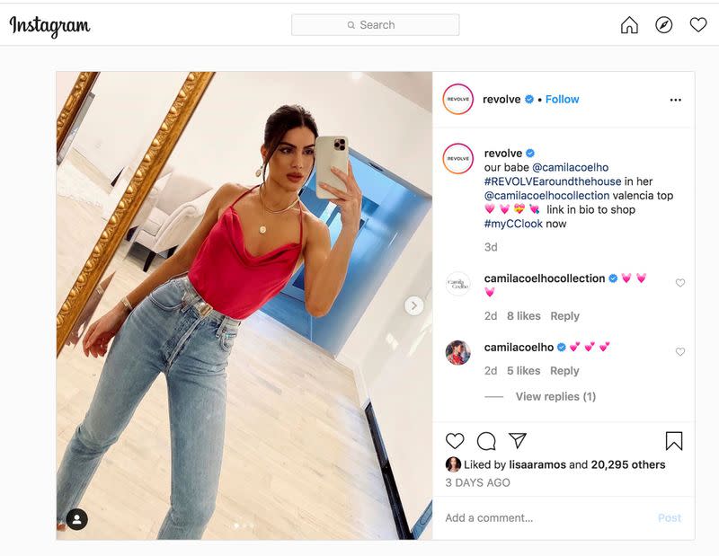 Model Camila Coelho wears a $130 magenta halter top she made in collaboration with brand REVOLVE