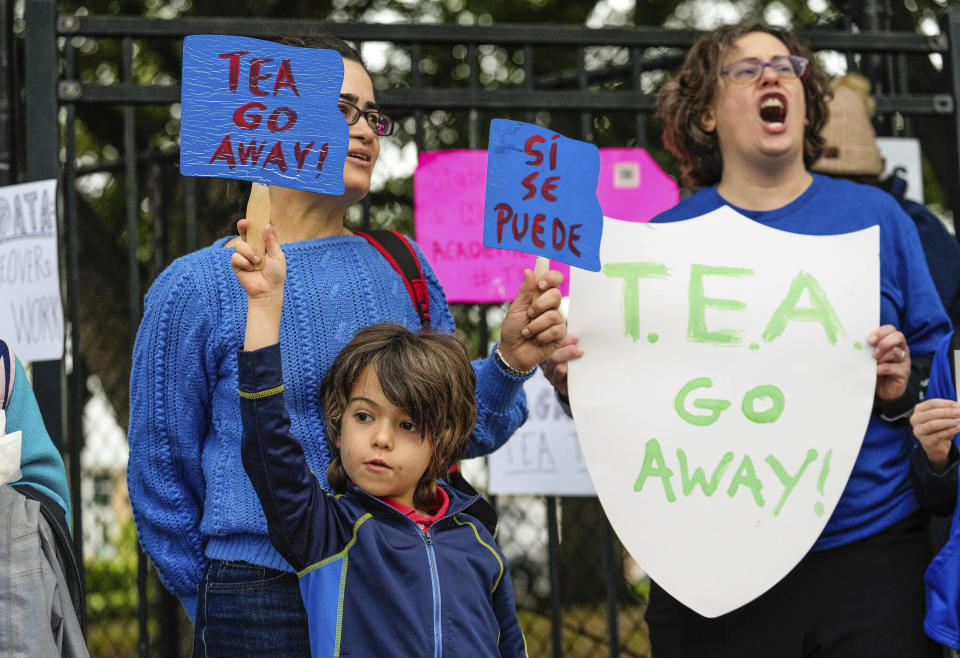 Diana Candida and her son Luca, 8, join parents and students from over 30 elementary, middle, and high schools across the Houston Independent School District gather for a day of protest to oppose the state takeover of HISD by the Texas Education Agency on Thursday, April 6, 2023, in Houston. (Raquel Natalicchio/Houston Chronicle via AP)