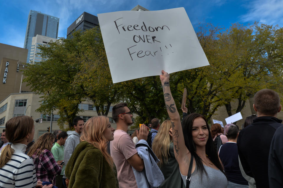 One person holding up a sign that says 'Freedom over fear!!!"