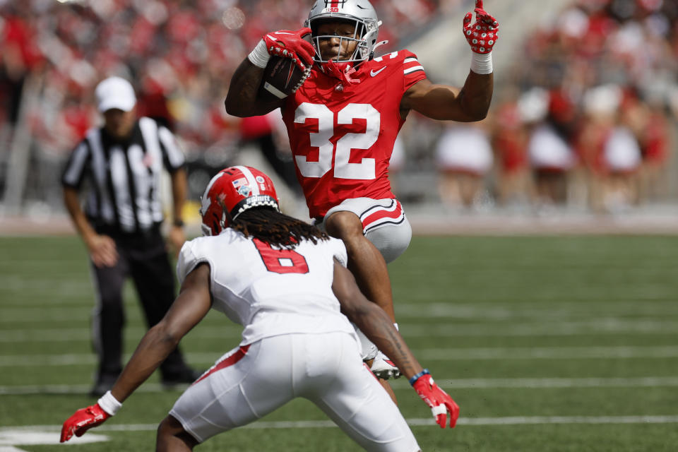 Ohio State running back TreVeyon Henderson, top, tries to hurdle Youngstown State defensive back Ezekiel Blake during the first half of an NCAA college football game Saturday, Sept. 9, 2023, in Columbus, Ohio. (AP Photo/Jay LaPrete)