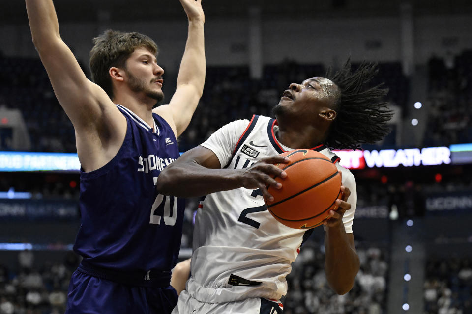 UConn's Tristen Newton shoots as Stonehill's Nathan McGill defends in the second half of an NCAA college basketball game, Saturday, Nov. 11, 2023, in Hartford, Conn. (AP Photo/Jessica Hill)