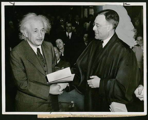 Einstein receives his certificate of American citizenship.