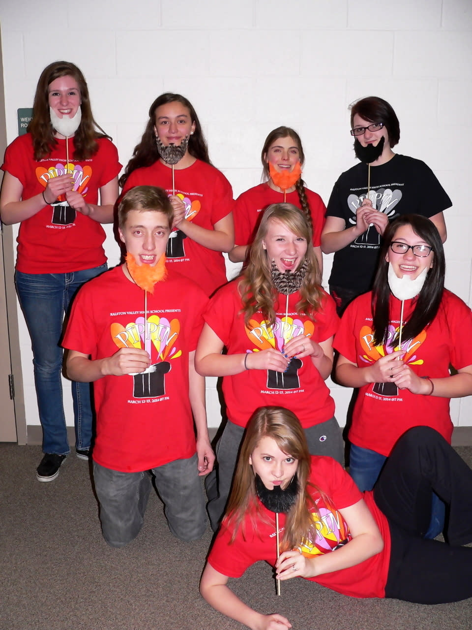 In this Friday, Feb. 28, 2014 photo, members of the Ralston Valley High School musical "Pippin," first row, Abbie Speed, 16; second row, from left, Patrick Heaton, 17, Autumn Ayers, 17, and Isabel Alvorado, 16; back row, from left, Serena Buxton, 16, Valeria de Luna-Kent, 16, Natalie Sarver, 16, and Tia Crane, 16, model leprechaun beards in Arvada, Colo. Making and taking handmade St. Patrick's Day props cranks up the fun at parades and parties. It turns spectators into participants. (AP Photo/Jennifer Forker)