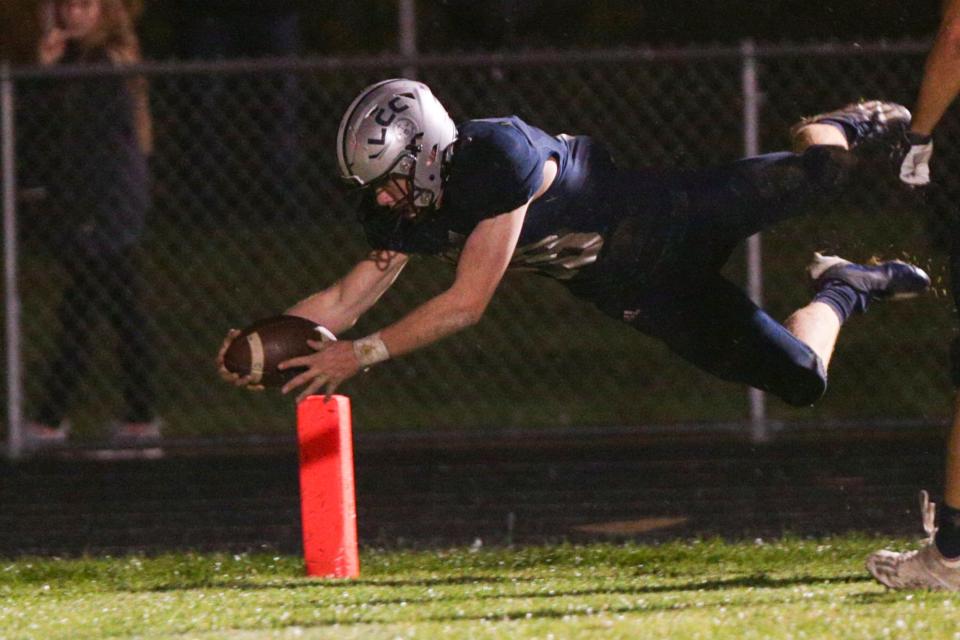 Central Catholic's Nick Page (18) dives into the end zone to score on an interception during the fourth quarter of an IHSAA football game, Friday, Oct. 22, 2021 in Lafayette.