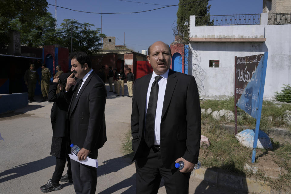 Shah Khawar, center, special prosecutor from Pakistan's Federal Investigation Agency, leaves after hearing of the Cipher case against former Prime Minister Imran Khan, at a special court in Adiyala prison, in Rawalpindi, Pakistan, Monday, Oct. 23, 2023. A Pakistani court on Monday indicted Khan on charges of revealing official secrets after his 2022 ouster from office in another slap to the former prime minister who will likely be unable to run in the upcoming parliamentary elections in late January. (AP Photo/Anjum Naveed)