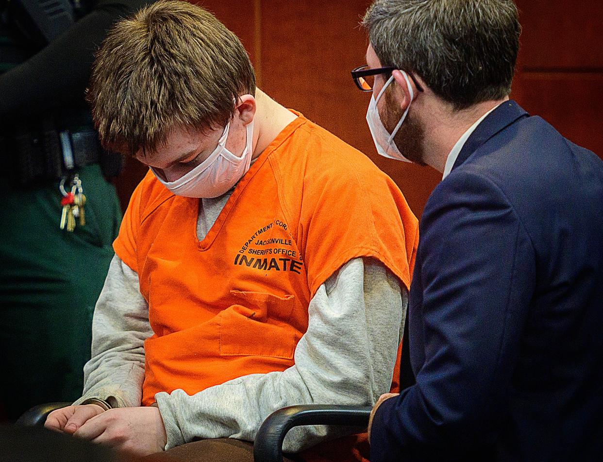 Aiden Fucci, 15, talks with his attorney, Josh Mosley, before a pretrial hearing before Circuit Judge Lee Smith in the St. Johns County courthouse on Wednesday, Feb. 2, 2022. Fucci is accused of killing 13-year-old Tristyn Bailey in May 2021.