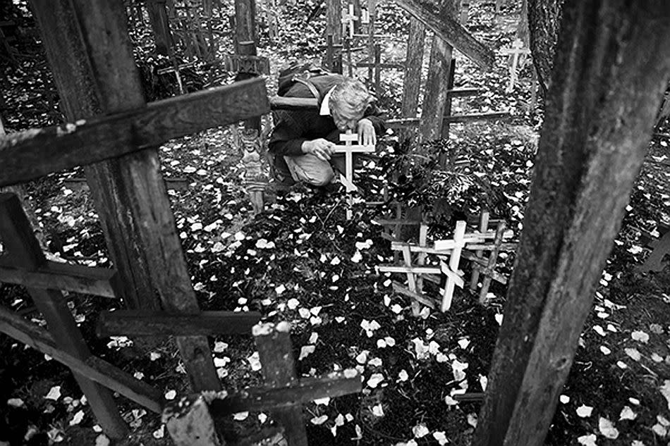 Grabarka, Poland. <br><br>The pilgrims place their crosses into the ground of the holy mountain and start to pray. This tradition, which goes back to the 18th century, has caused the mountain to be covered with thousands of crosses. <br><br>Camera: Canon 5D MkII <br><br>Yurian Quintanas Nobel, Spain <br><br>Highly Commended, Cultures & Traditions portfolio