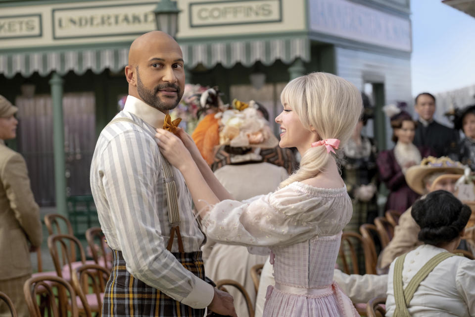 This image released by Apple TV+ shows Keegan-Michael Key, left, and Dove Cameron in a scene from "Schmigadoon!,” premiering Friday. (Apple TV+ via AP)