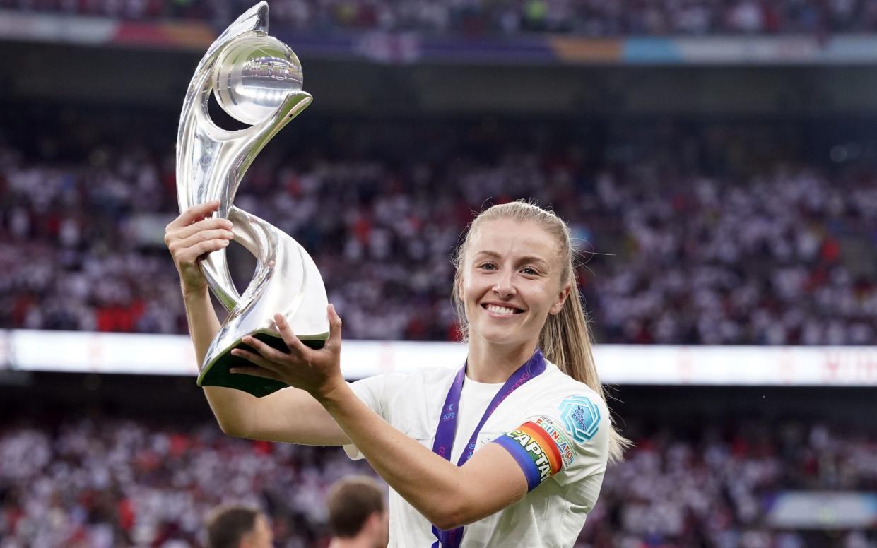 England football player Leah Williams, who is doubtful will pay in the England vs USA match on Friday, holds European Champions trophy - PA