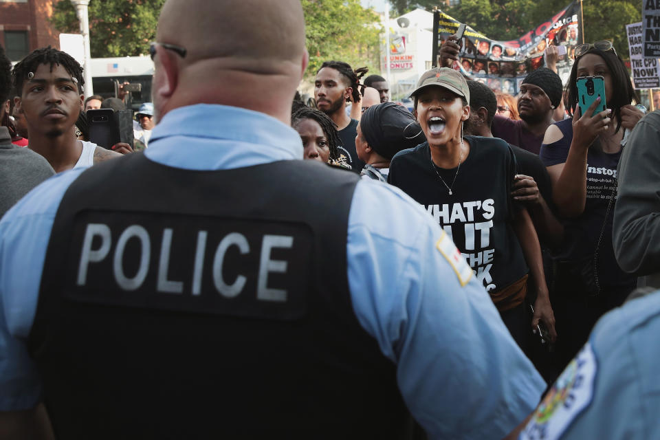<p>Demonstrators in the South Shore neighborhood protesting the shooting death of 37-year-old Harith Augustus have a heated exchange with police on July 15, 2018 in Chicago, Ill. (Photo: Scott Olson/Getty Images) </p>
