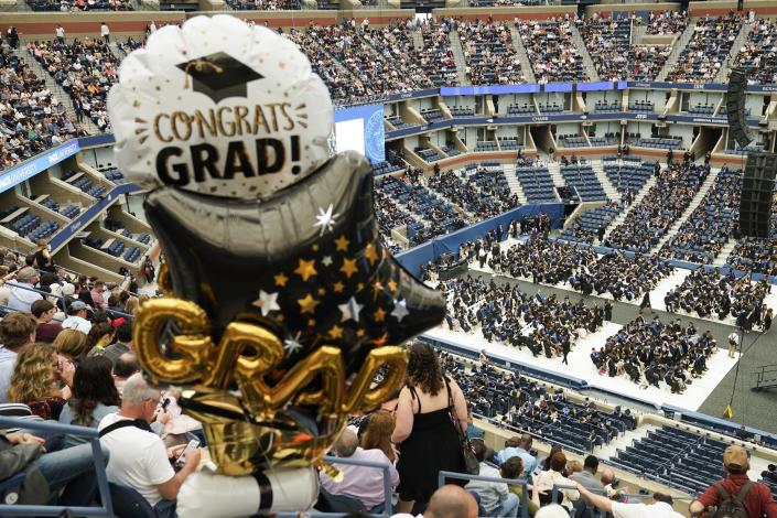 Parents looks down on graduates below as a graduation ceremony begins for Pace University  in New York, Monday, May 16.