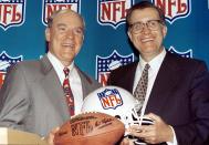 FILE - Houston businessman Bob McNair, left, and NFL commissioner Paul Tagliabue smile during a press conference in Atlanta, in this Wednesday, Oct. 6, 1999, file photo. Houston rejoined the NFL, paying a record $700 million for an expansion franchise. During Paul Tagliabue’s 17-year stint as commissioner, the NFL experienced labor peace, saw skyrocketing television deals, construction of new stadiums across the nation and expansion to the current 32-team makeup. Despite those credentials that continued pro football’s surge to the top of American sports, it took until a special centennial class in 2020 for Tagliabue to be voted into the Pro Football Hall of Fame after retiring in 2006. (AP Photo/W. A. Harewood, File)