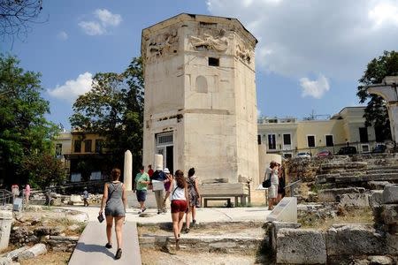 Tourists visit the Tower of the Winds, open to the public for the first time in more than 200 years after being restored, in the Roman Agora, in Plaka, central Athens, Greece, August 23, 2016. REUTERS/Michalis Karagiannis