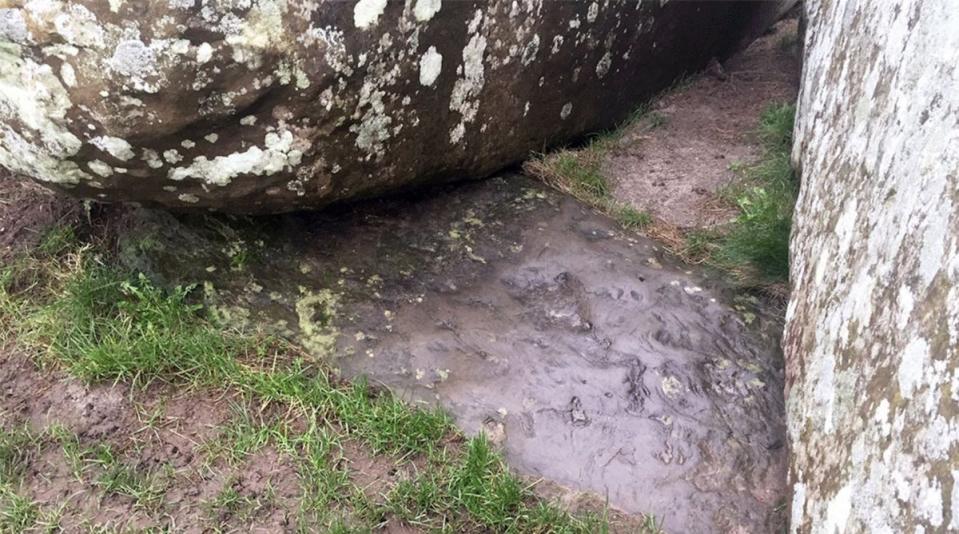 The now partly buried (sunk into the ground) altar stone (English Heritage)