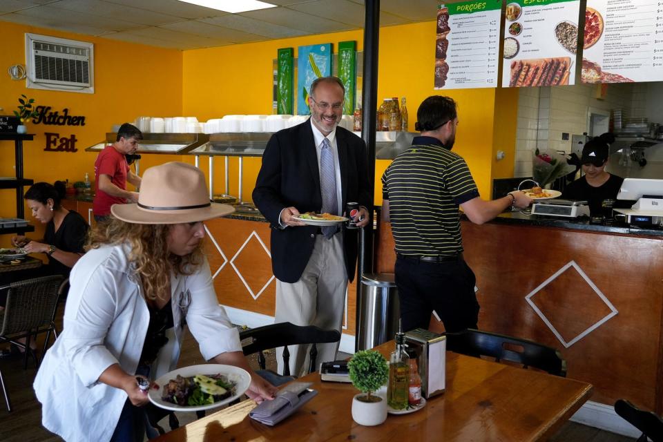 Treasurer candidate Stefan Pryor takes a lunch break with his campaign volunteers and staff at the Ponto Um Brazilian restaurant in East Providence on Aug 24.